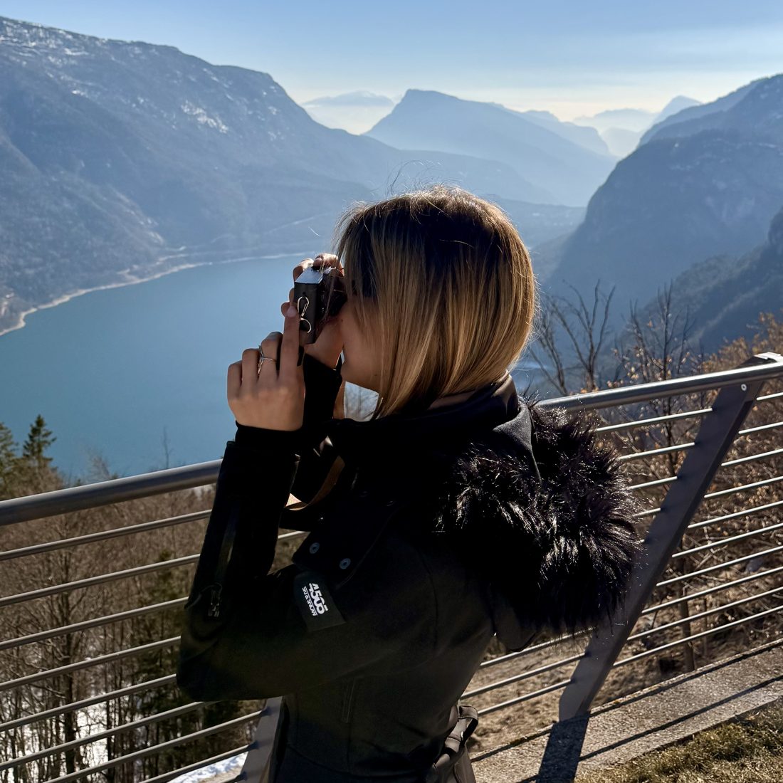 Coralie photographing a mountain lake